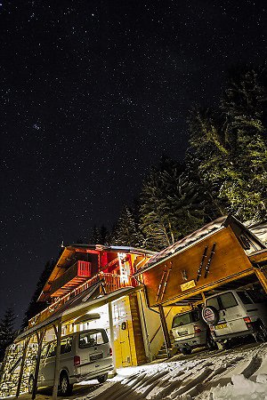 Home. Chalet from the road view at night